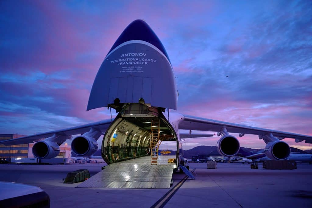 Antonov aircraft unloading cargo on the ramp at sunset at SBD airport