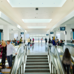 A photograph of travelers in San Bernardino International Airport's busy passenger concourse
