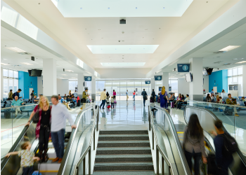 A photograph of travelers in San Bernardino International Airport's busy passenger concourse