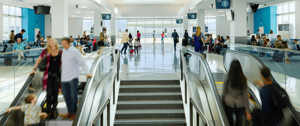 A photograph of travelers in San Bernardino International Airport's busy passenger concourse