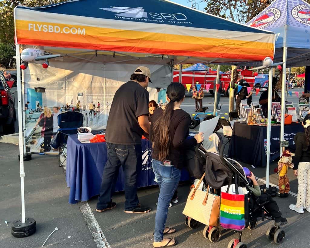 Attendees of Coptoberfest visting the San Bernardino International Airport booth